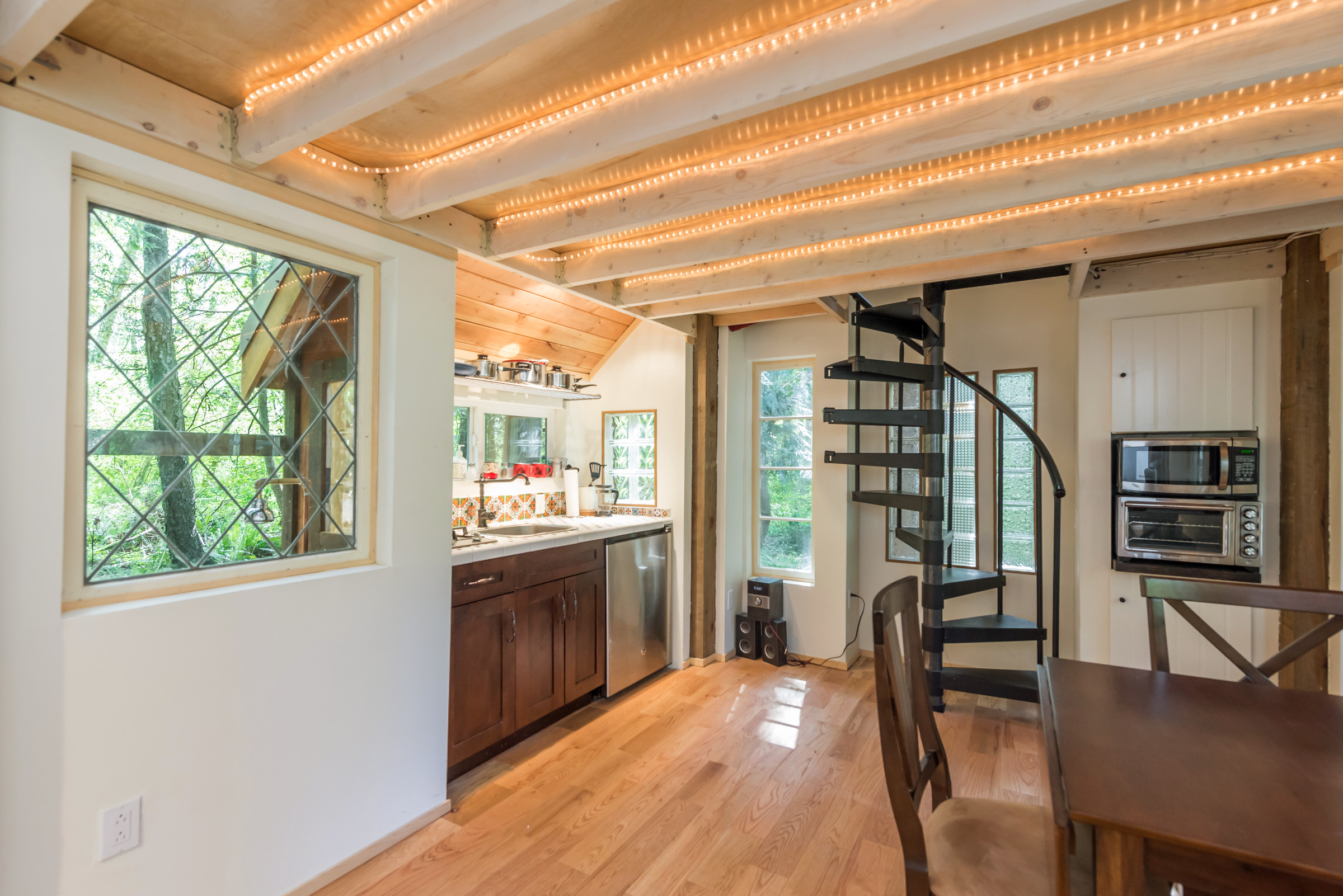 The living room of the Gingerbread cottage in Point Roberts surrounds you in visions of cedars and ferns through antique windows.